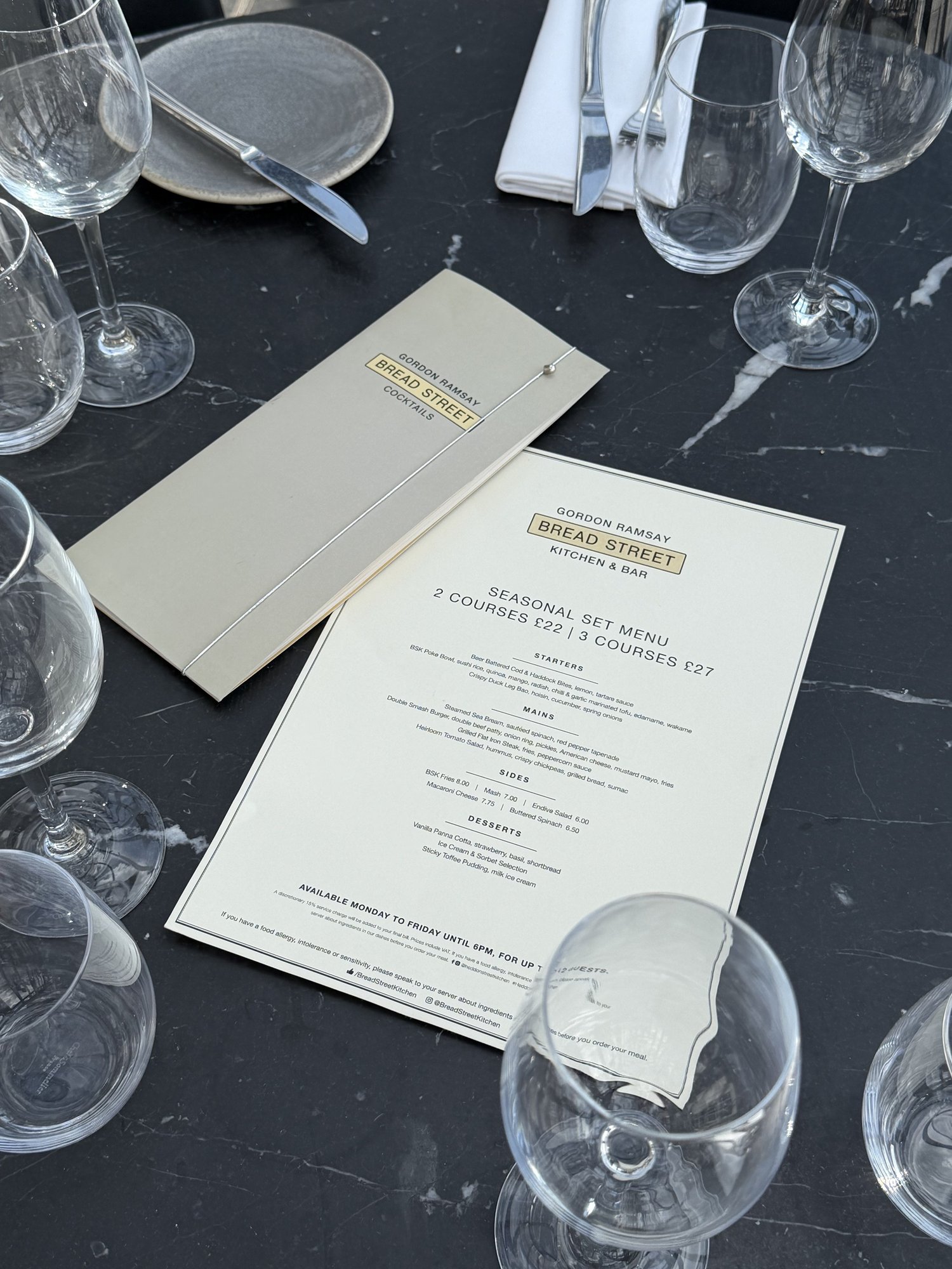 The printed Bread Street Kitchen seasonal set menu on a black marble table