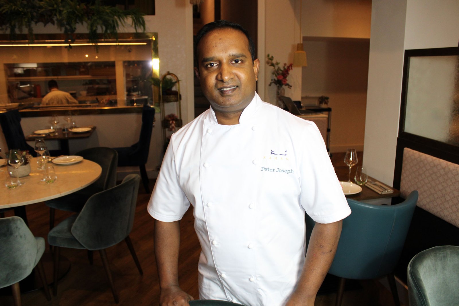 Chef Patron Peter Joseph in chef whites in the dining room at Kahani