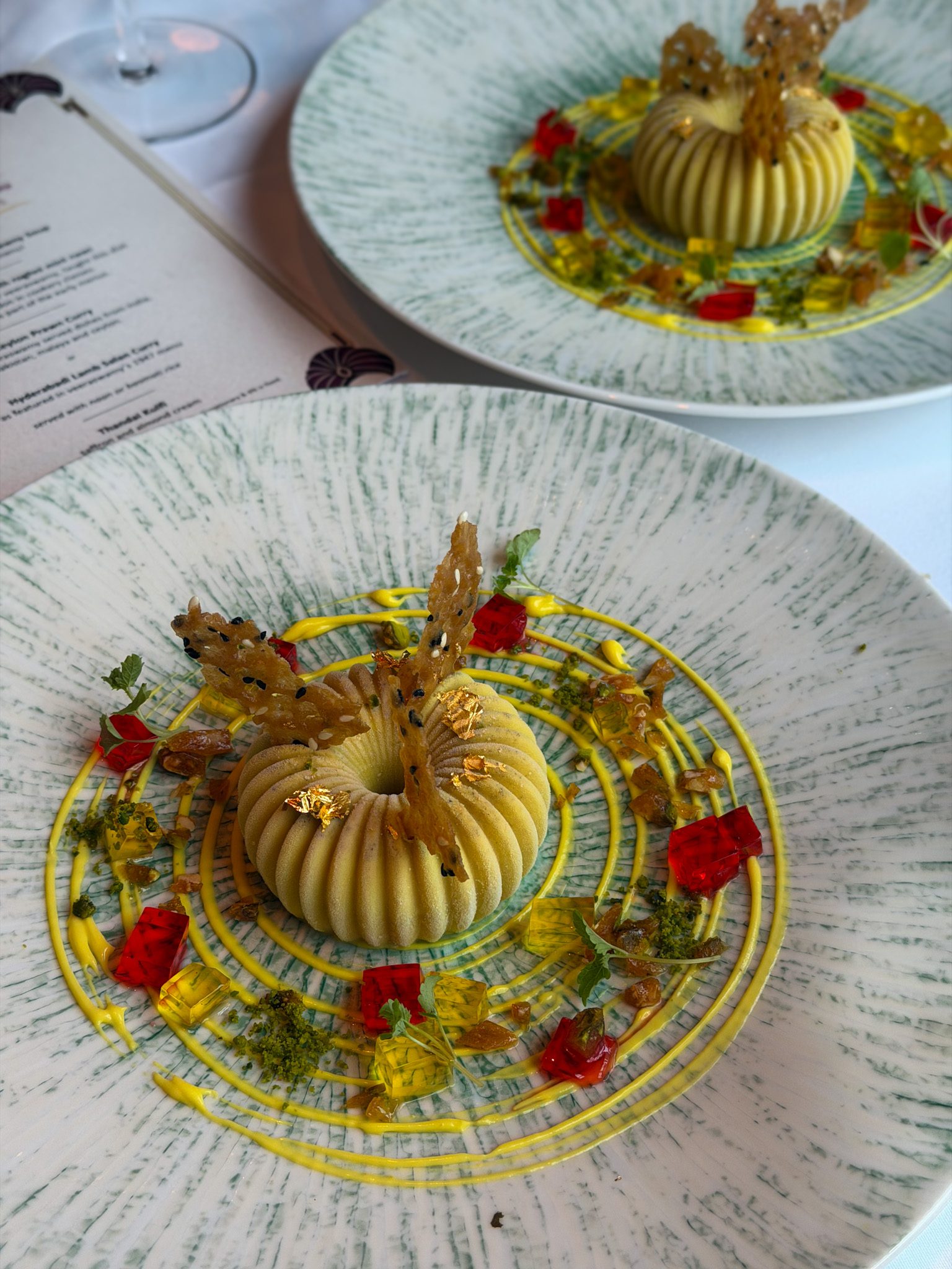 The thandai kulfi on its plate beside the printed Centenary Menu card